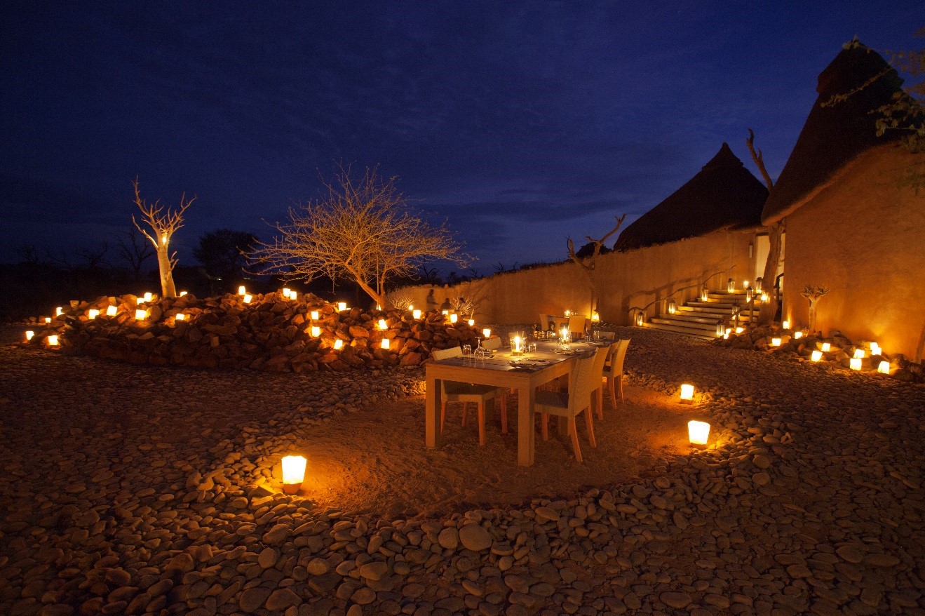 a blue hour photo of little kulala lodge at dinner time