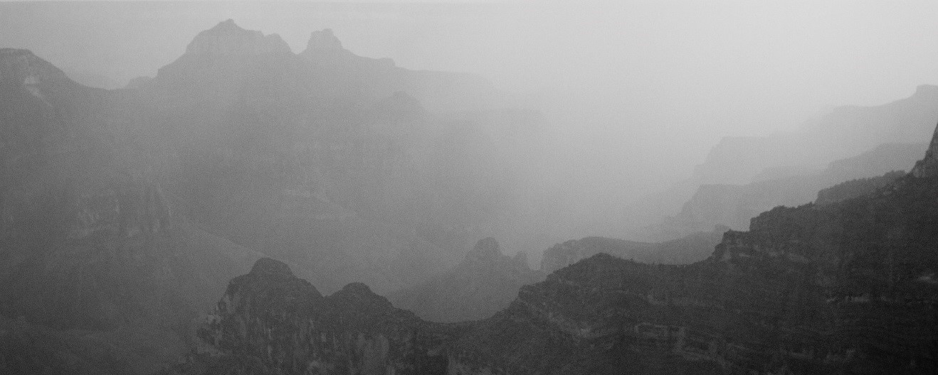a black and white photo of part of the grand canyon