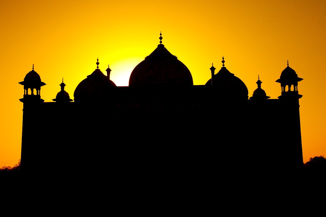 a striking silhouette of a building in india at sunset