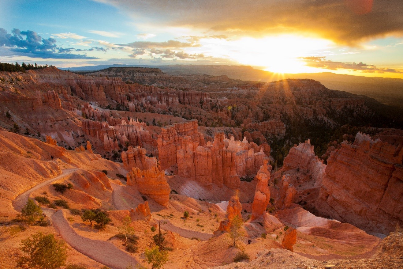 a special photo of bryce canyon at sunrise with sunburst over the horizon