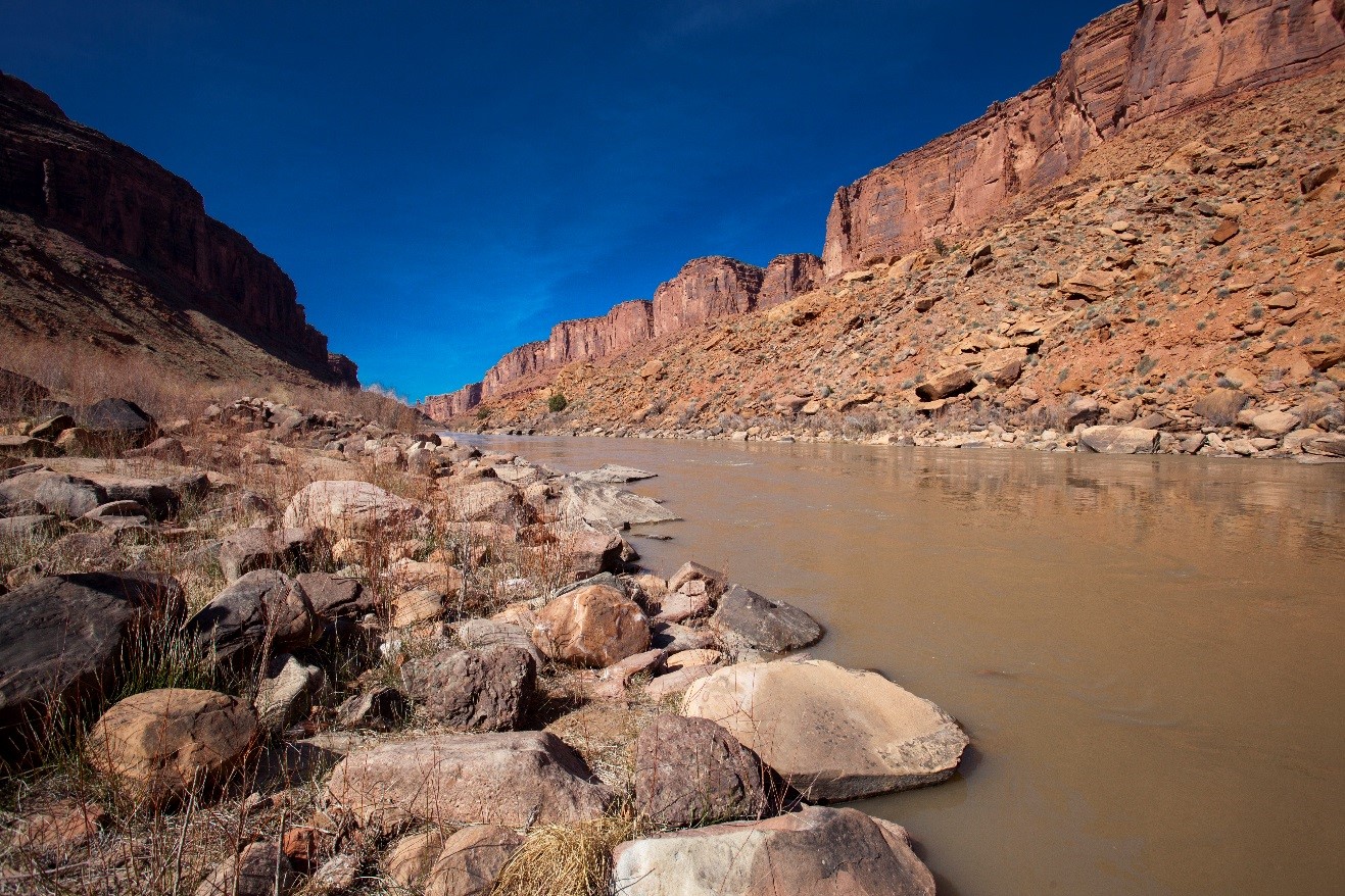 a crisp photo of blue sky above the mighty colorado river, flowing near Moab, Utah