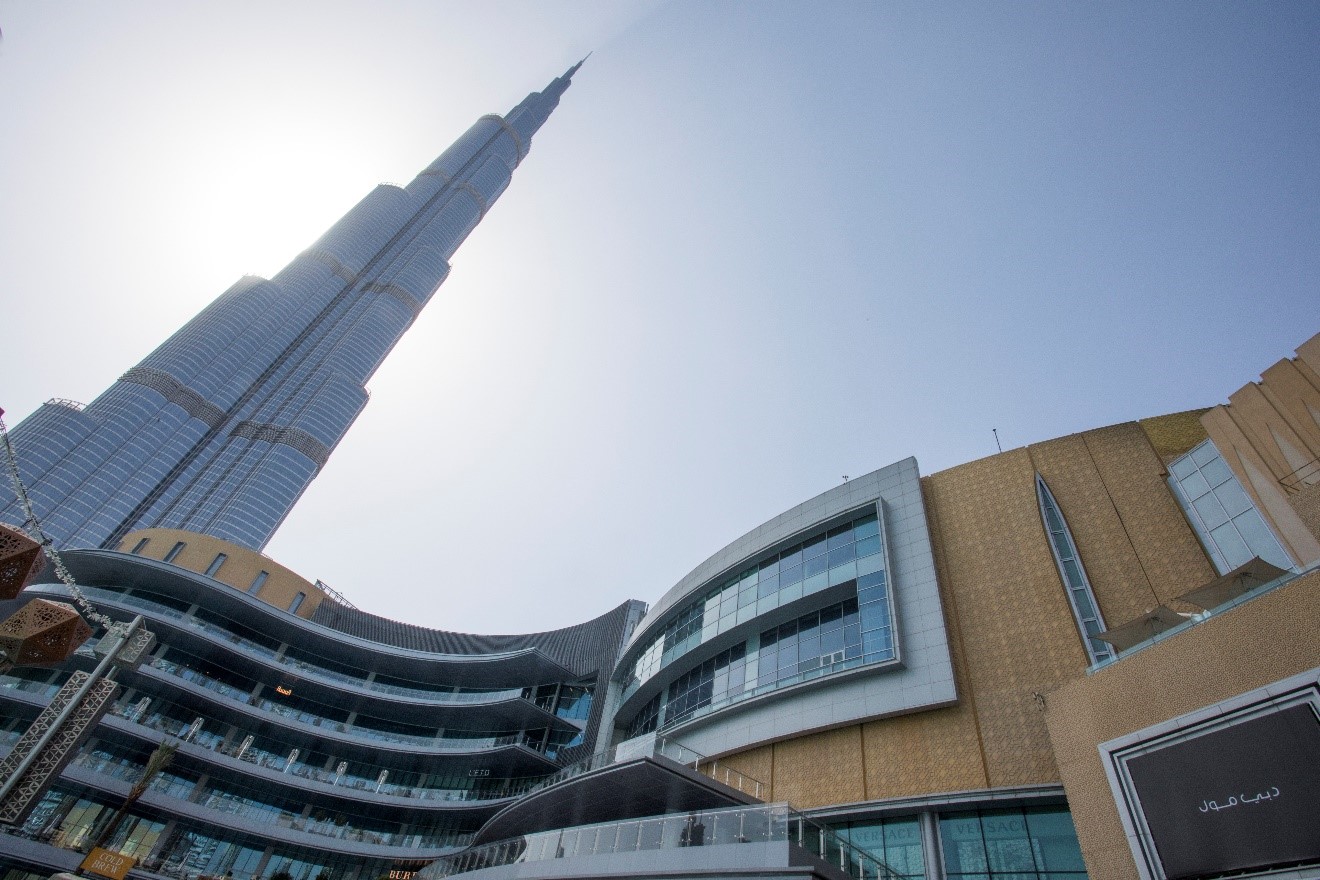 an outside, below view of the burj khalifa towering over the Dubai Mall