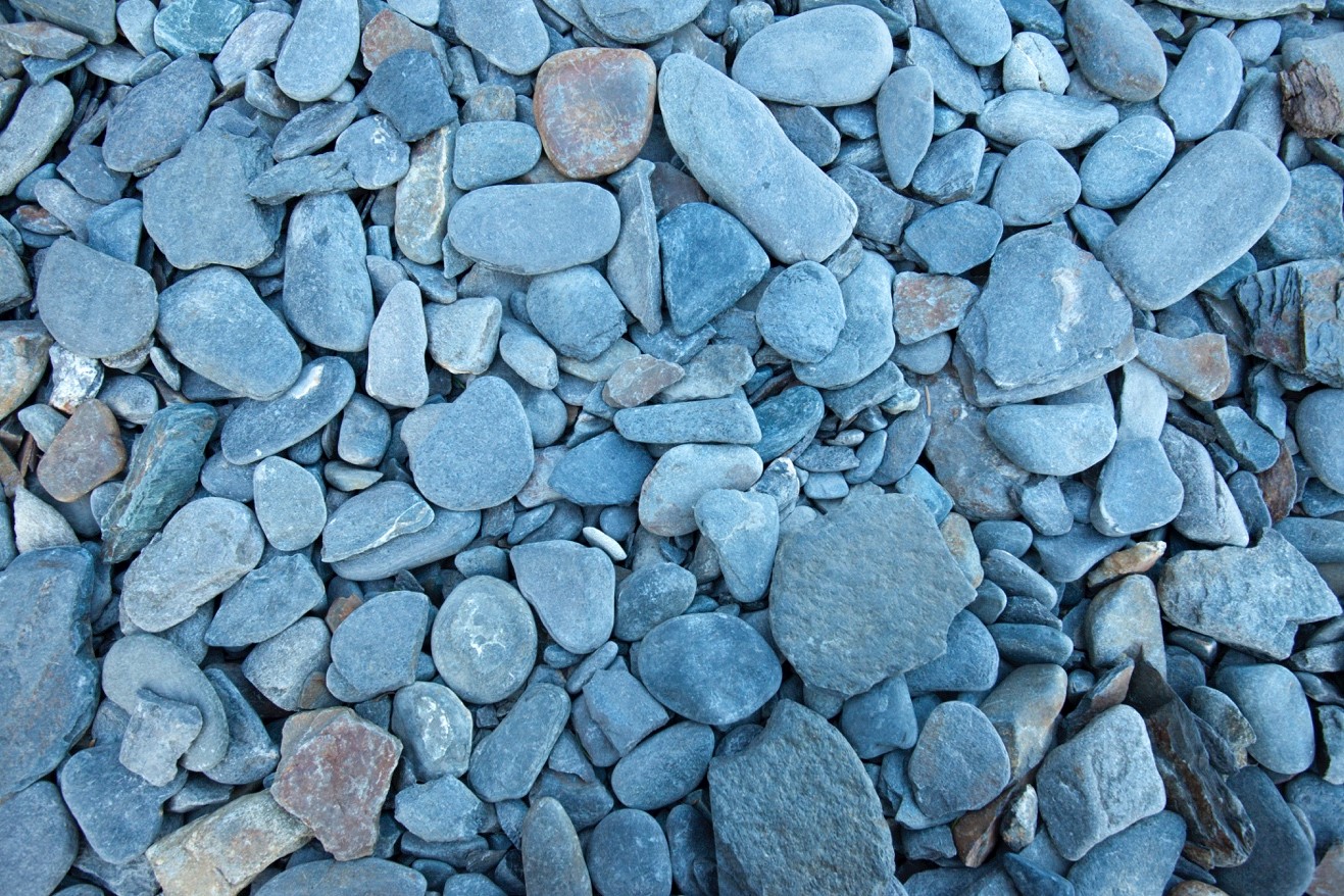 a photo of flat stones on the shore of resurrection bay at fox island