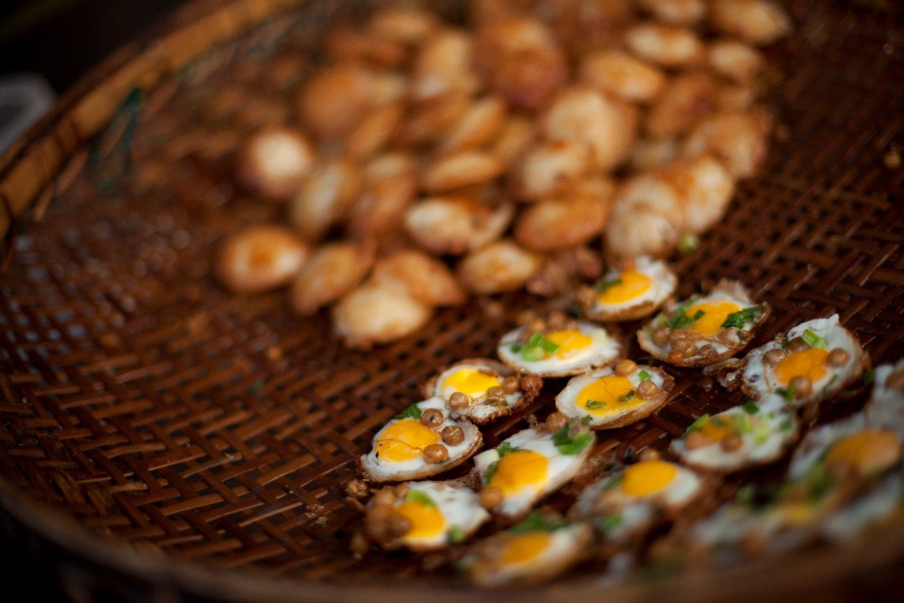 a narrow aperture photo of food at a stall in Myanmar