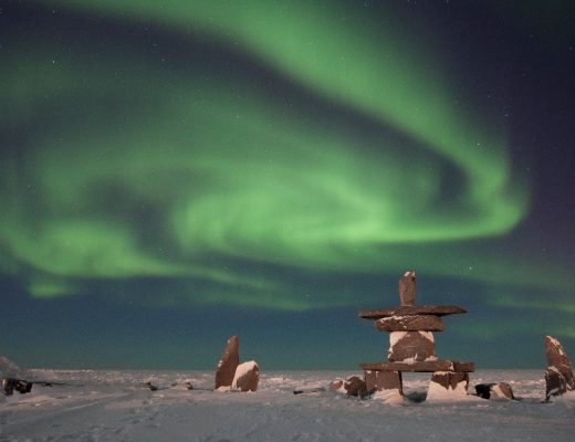 a stunning swirling aurora over the churchill inushuk on the shores of hudson bay