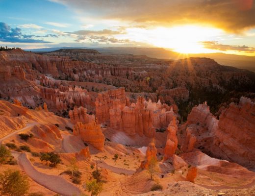 a special photo of bryce canyon at sunrise with sunburst over the horizon