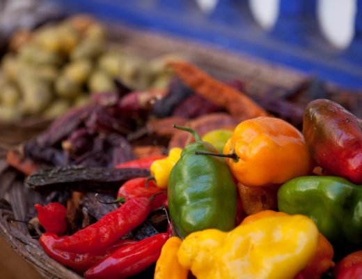 a colorful photo of peppers and other foods at a restaurant in Cusco