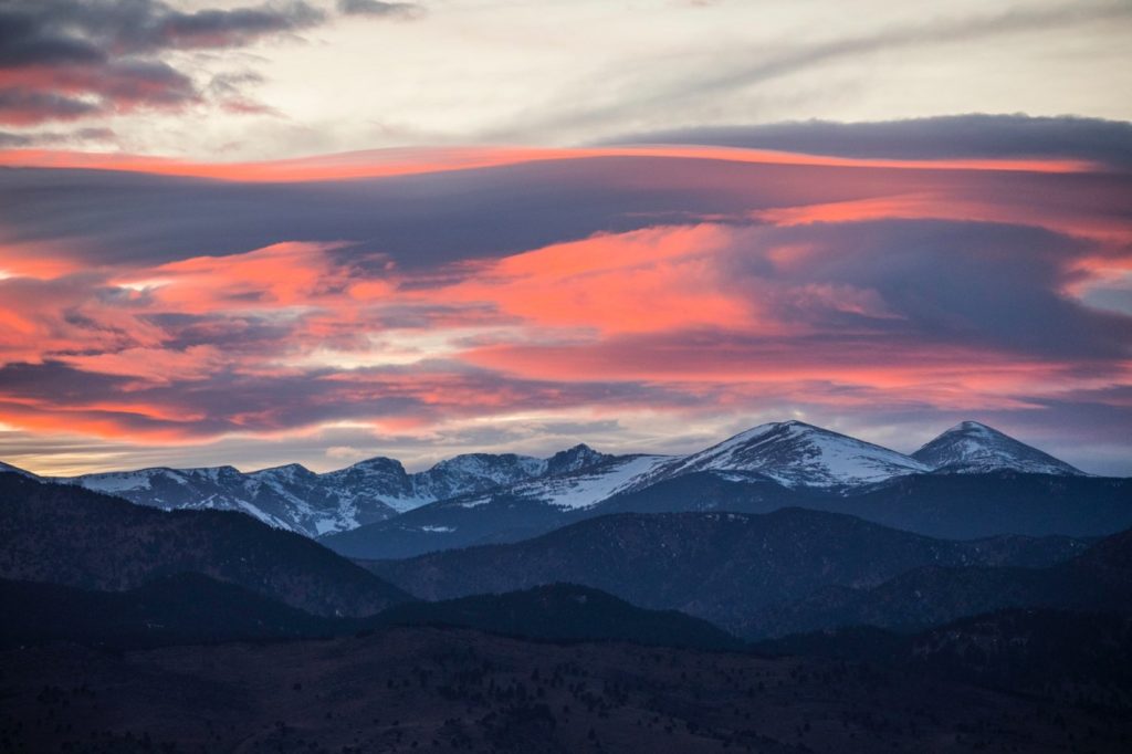 a pink sunset over the rocky mountains