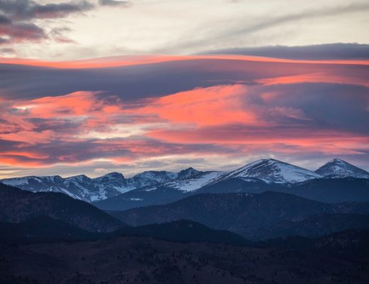 a pink sunset over the rocky mountains