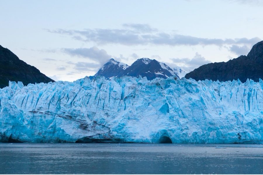 a beautiful blue glacier spans edge to edge in the frame