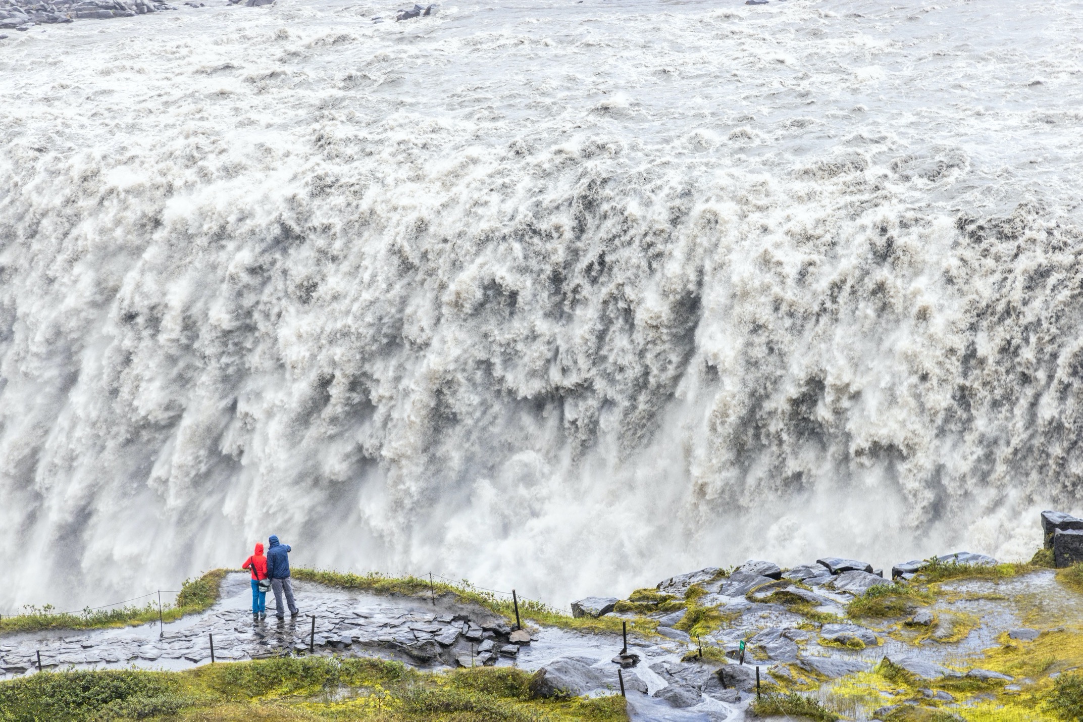 the mighty detifoss waterfall with visitors in front