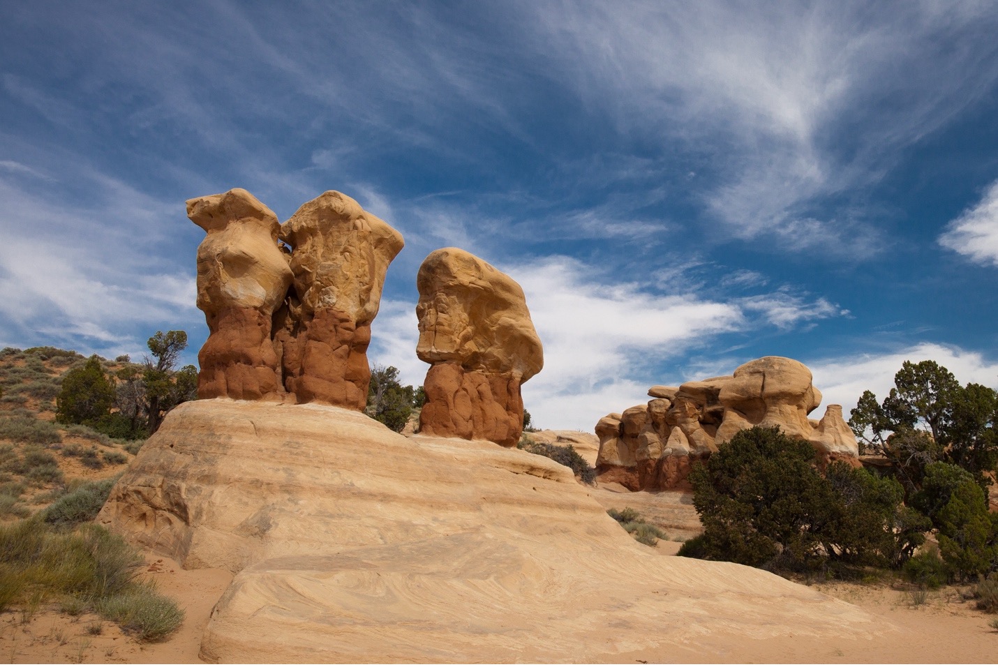 rock pillars in Escalante with a blue sky and wispy clouds