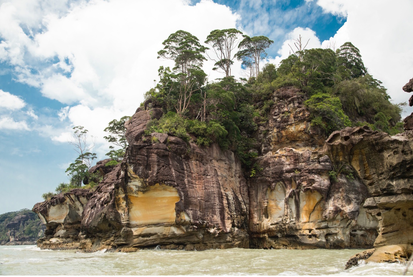 The limestone cliffs of Bako National park tower over the boat