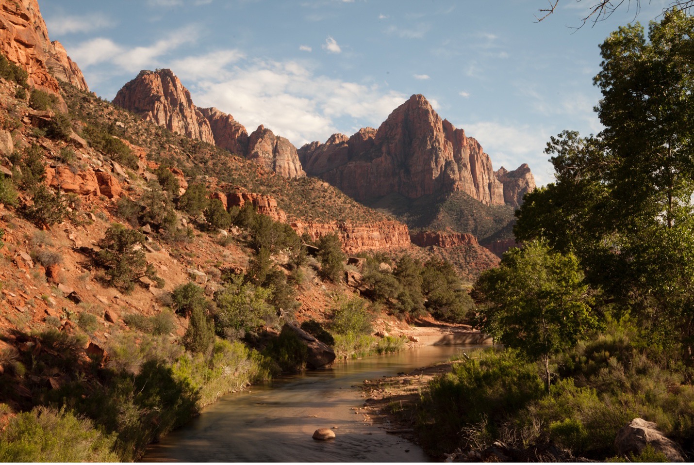 a view of zion national park with dark shadows