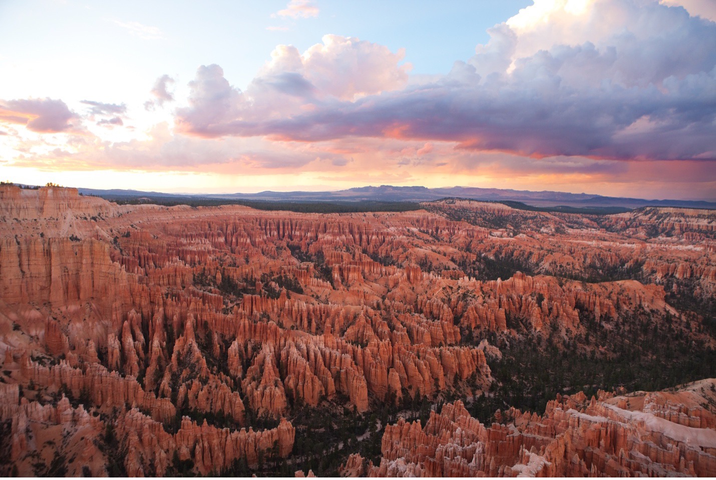 a sunset bathes bryce canyon in colorful light