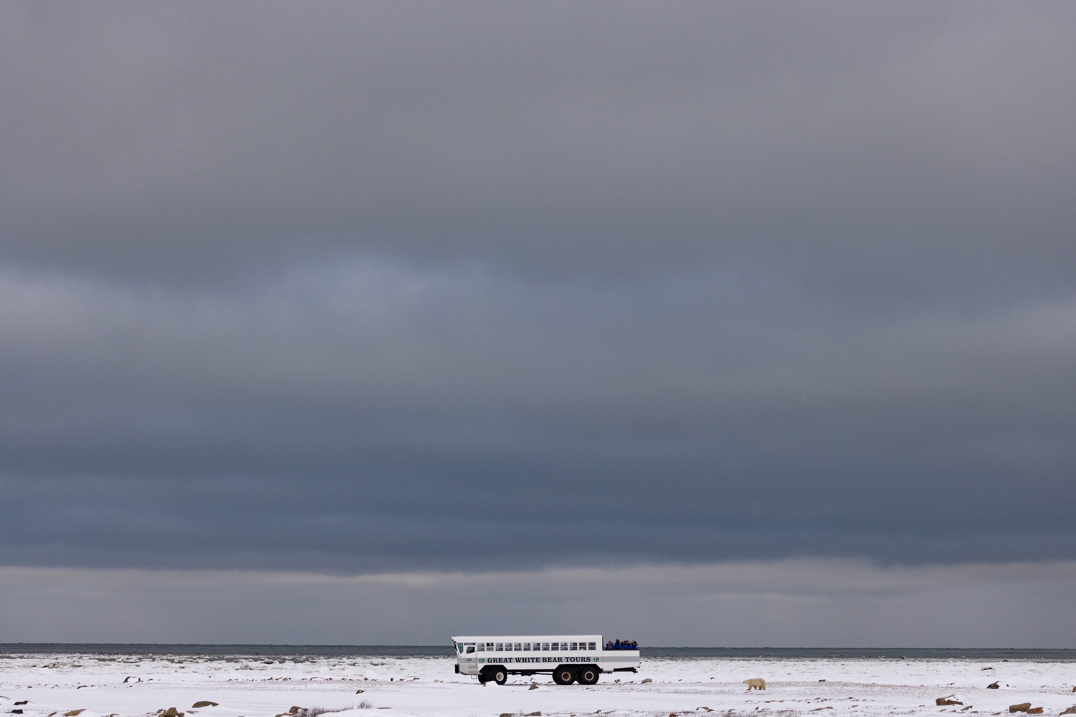 a polar rover sits on the tundra with a big sky