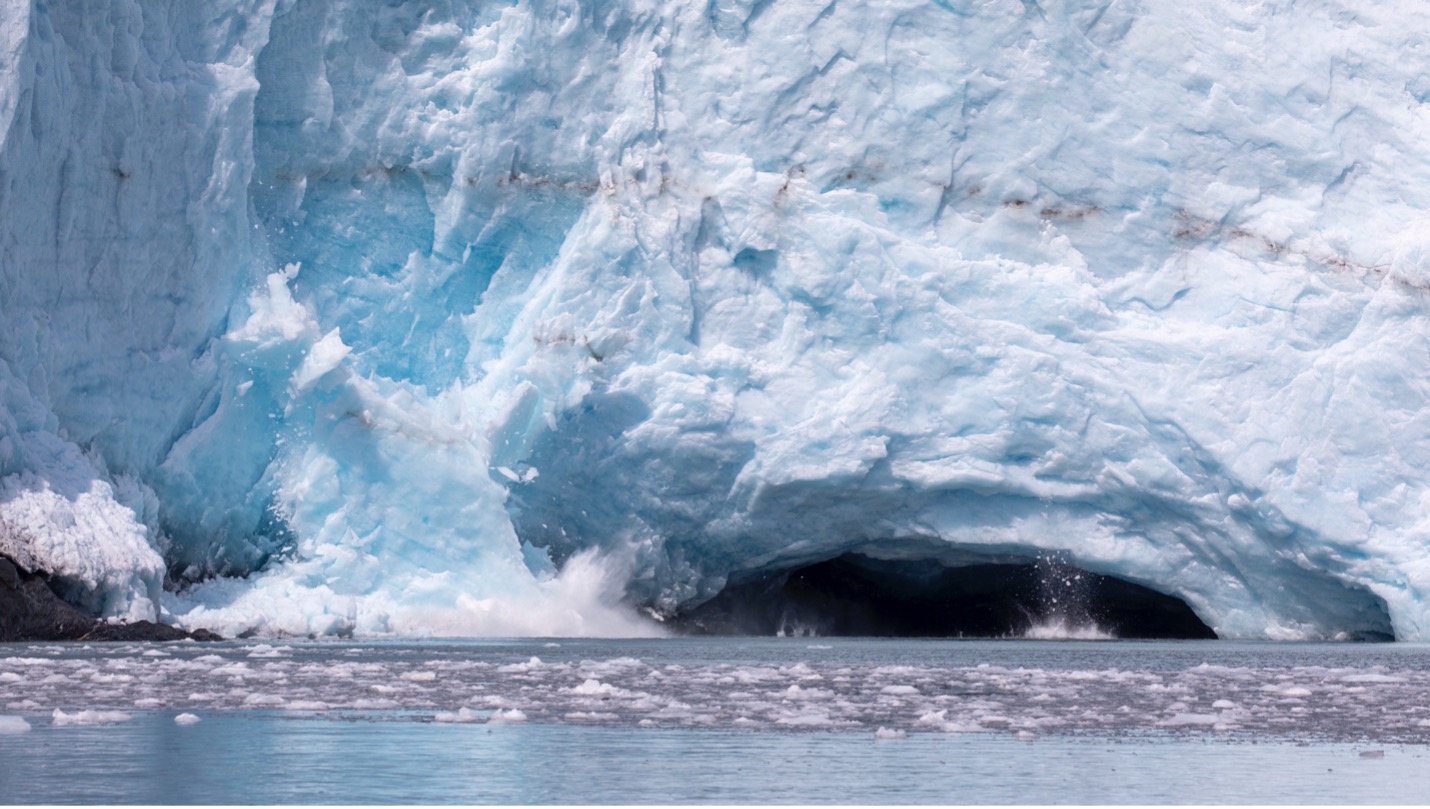 a calving glacier pours into the water