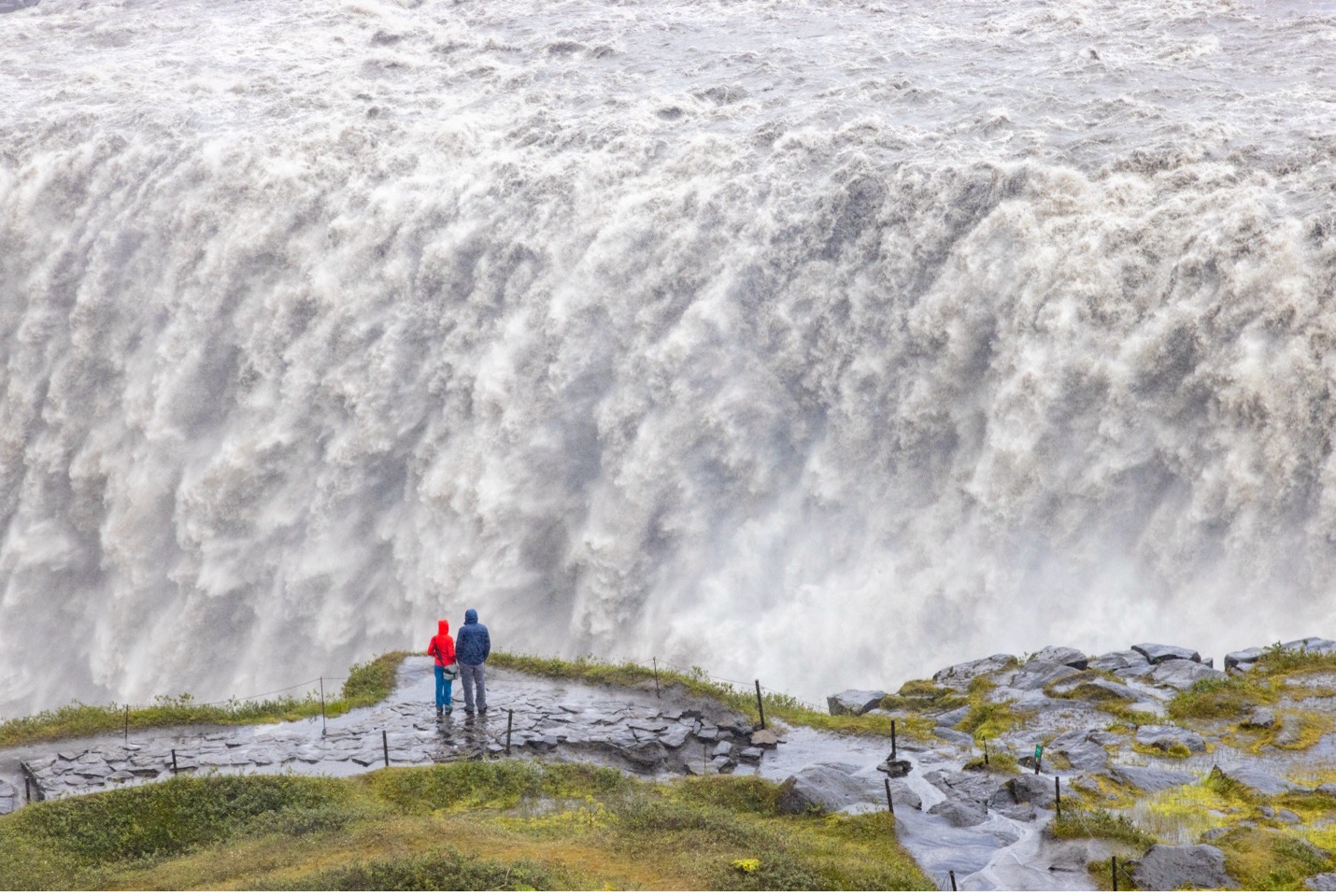 the mighty detifoss makes travelers look small