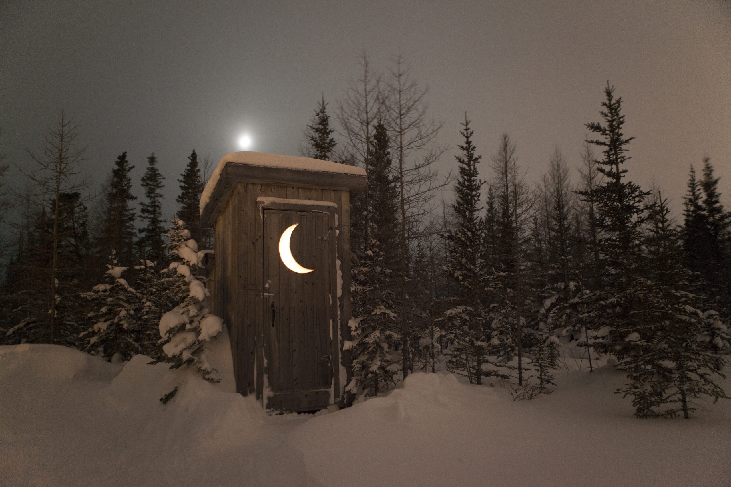 an outhouse in a winter arctic landscape