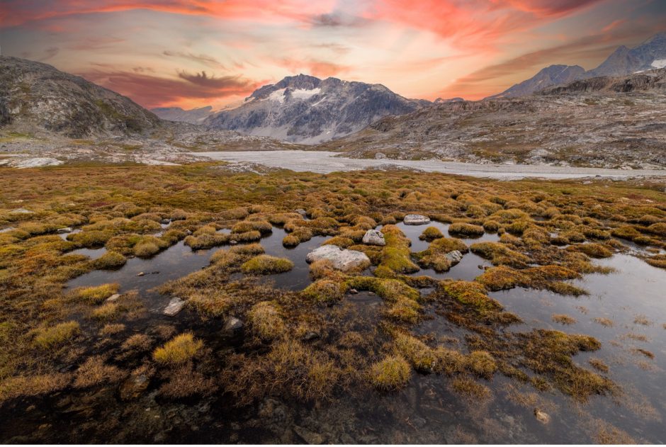 a beautiful sunset over a valley in Greenland