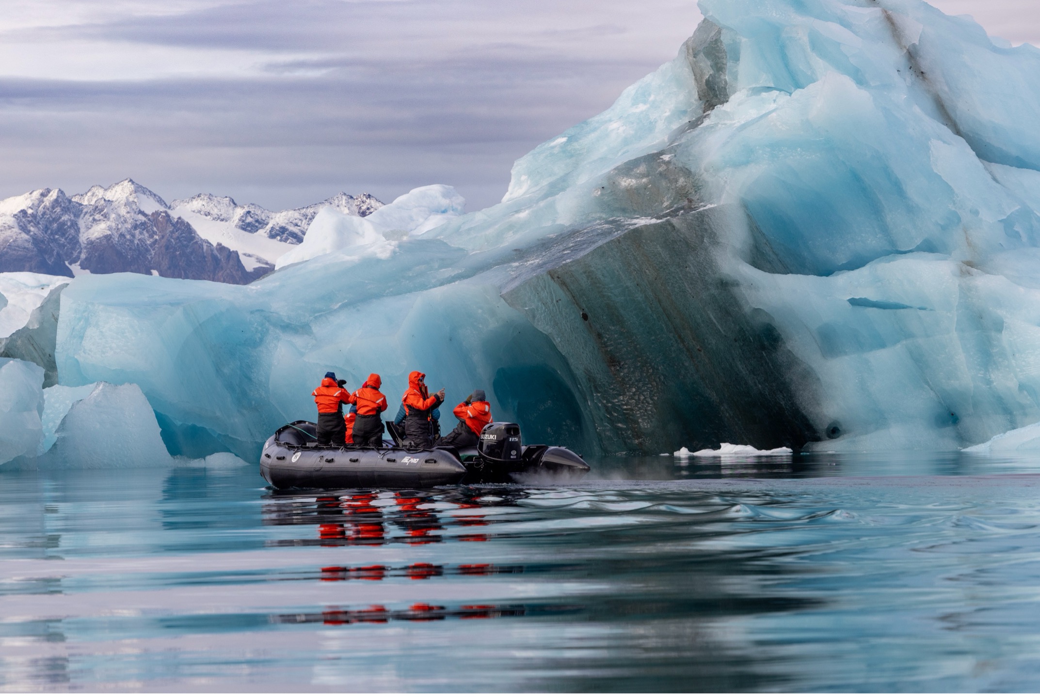 a group of photographers photograph a stunning iceberg in Greenland