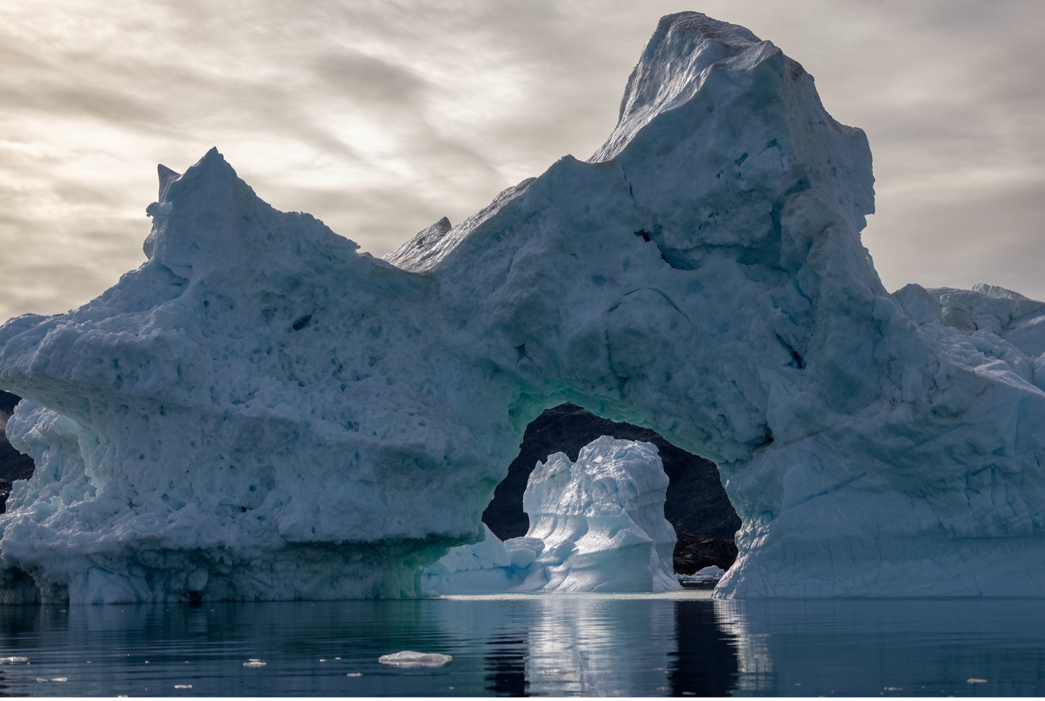 an iceberg archway in Greenland